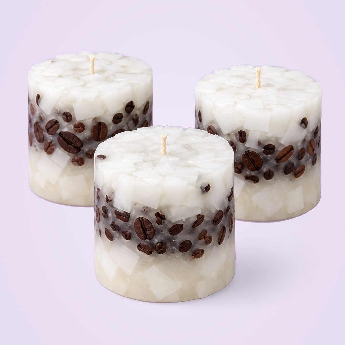 Three white chunk-wax coffee bean cup candles with a band of coffee beans