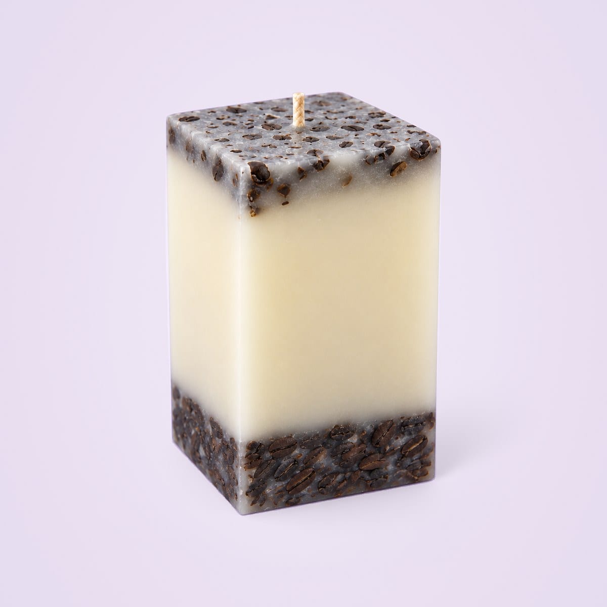 Square coffee bean pillar candle with a grey bean-flecked top, an ivory middle and a base of dark coffee beans