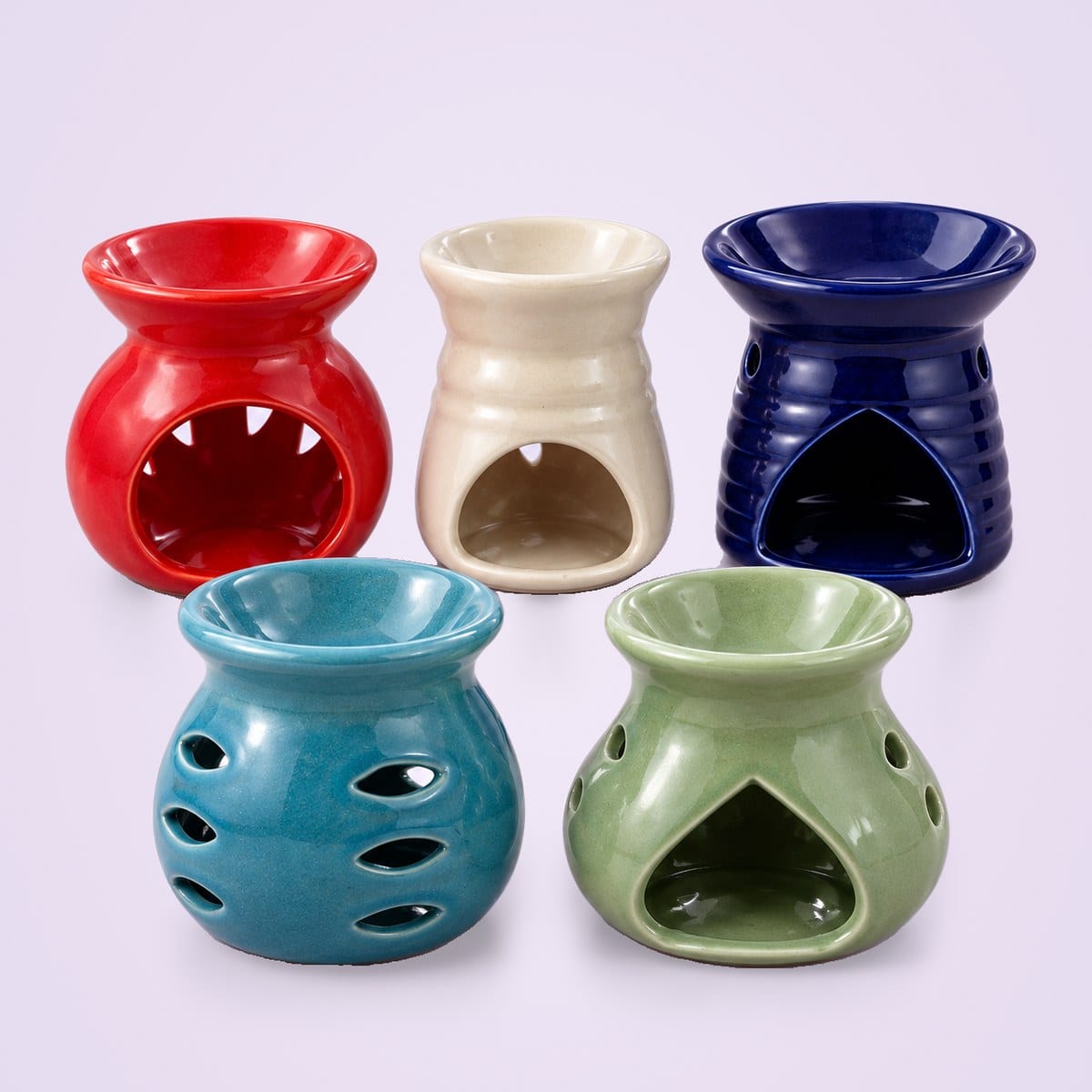 Five ceramic diffusers in teal, red, cream, navy and sage green, each a different shape