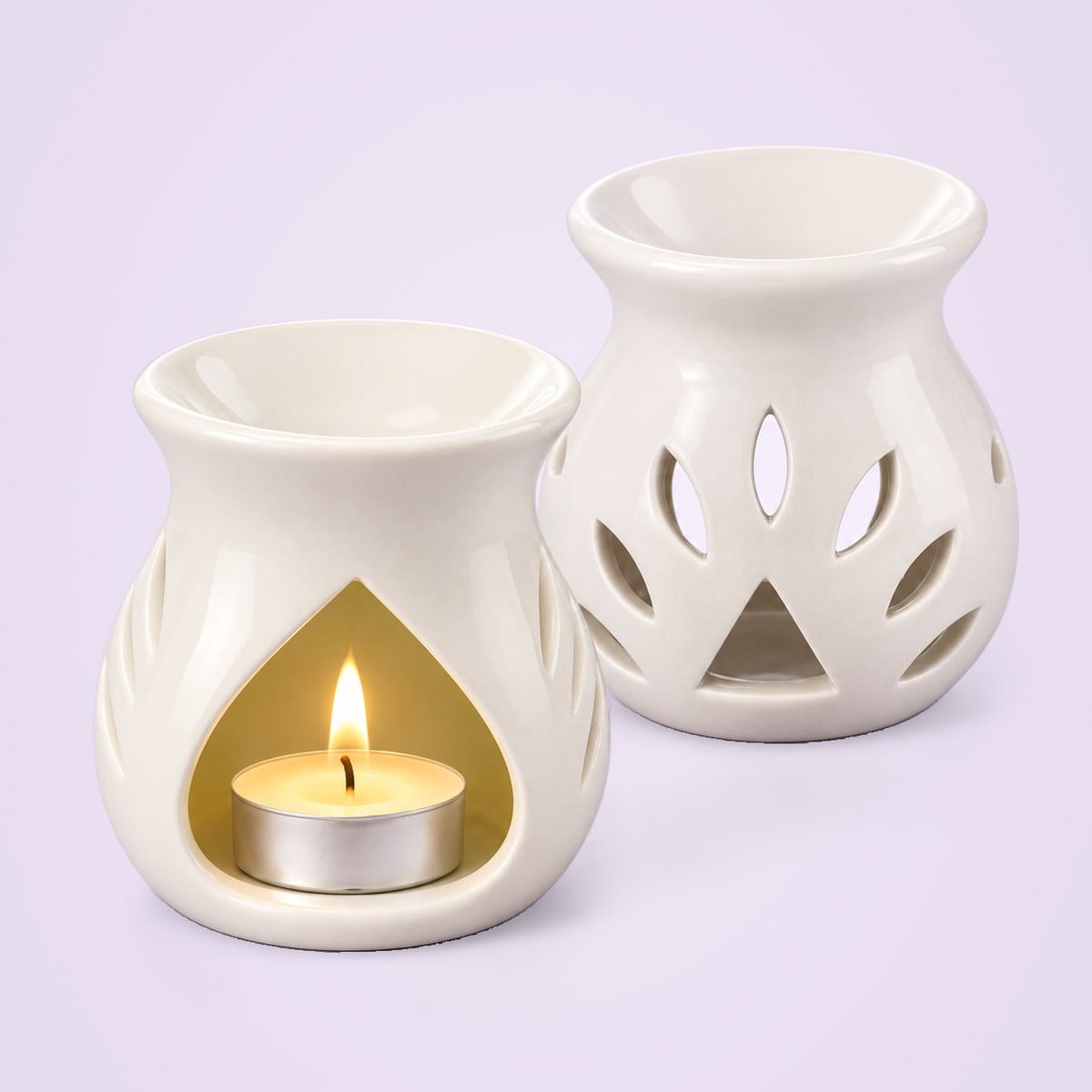 Two white ceramic diffusers, one with a lit tealight