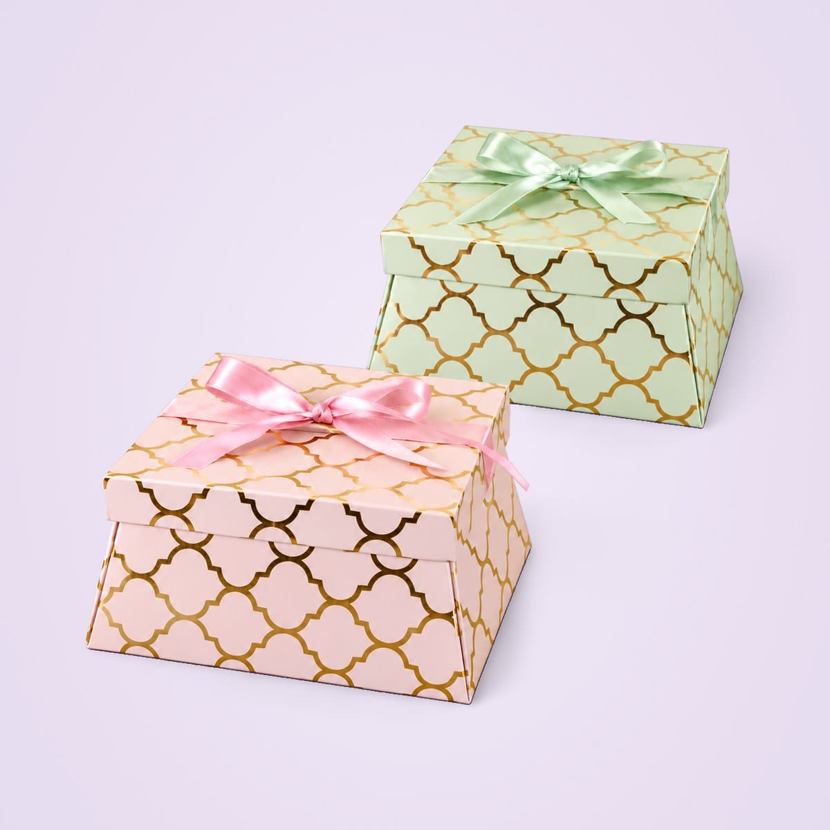 Gift Hamper 1 boxes in pink and pista green, closed, with gold lattice print and satin bows