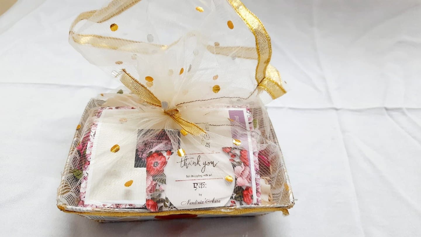Gift hamper wrapped in organza with a golden bow