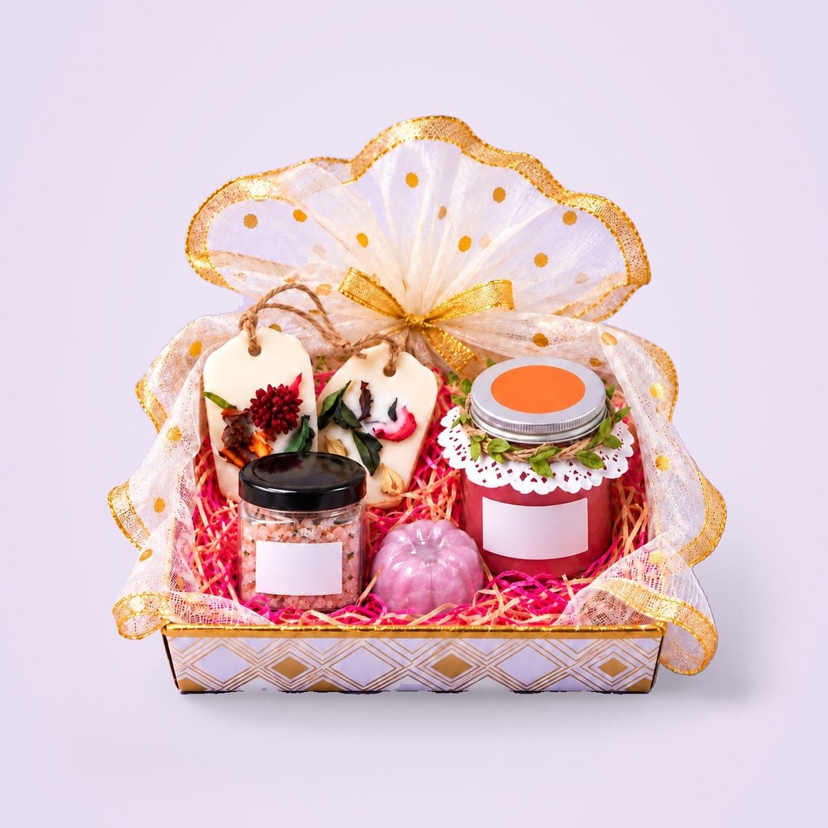 Gift hamper with a candle jar, wax sachets, bath salt and soap in organza