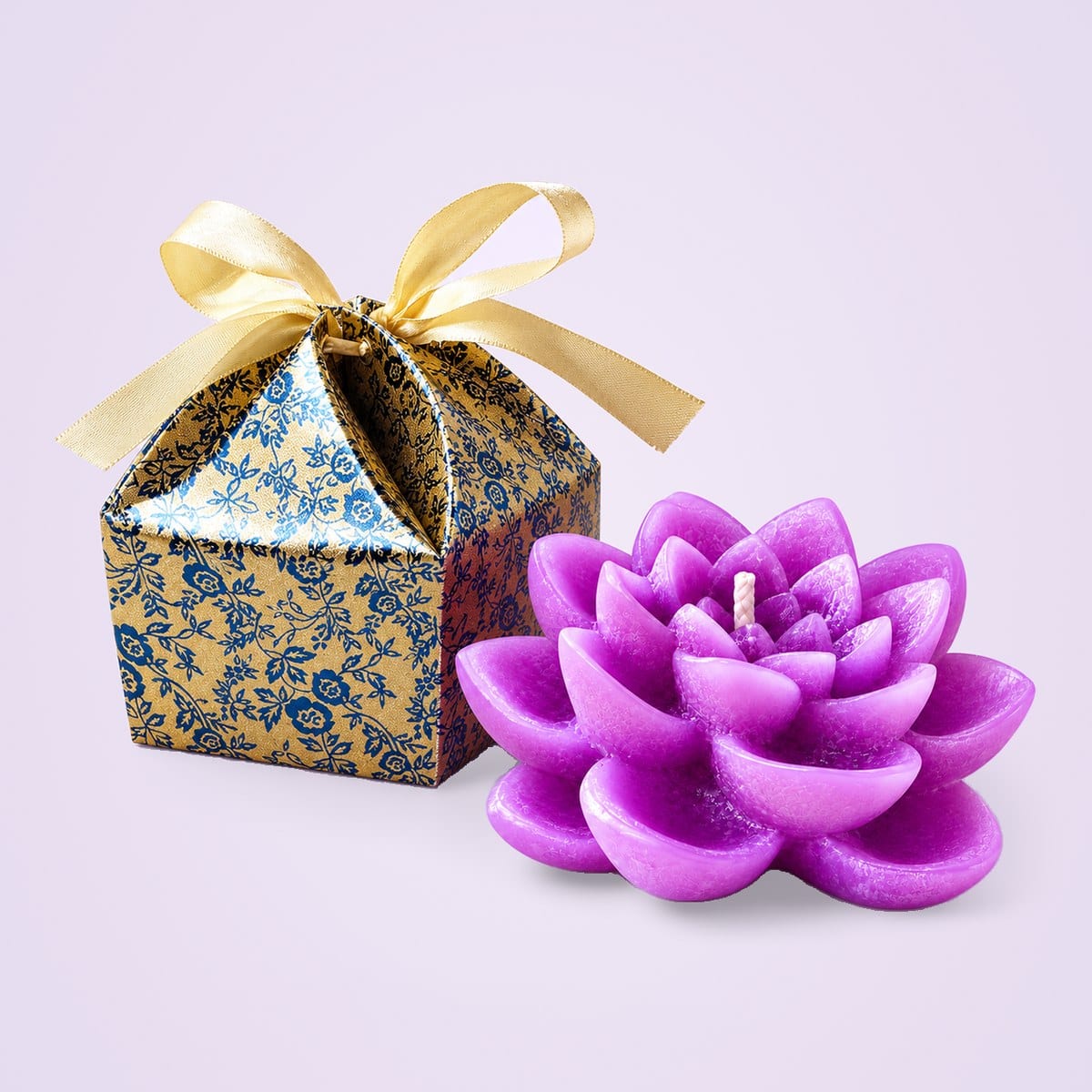 Lavender lotus candle beside its printed gift box