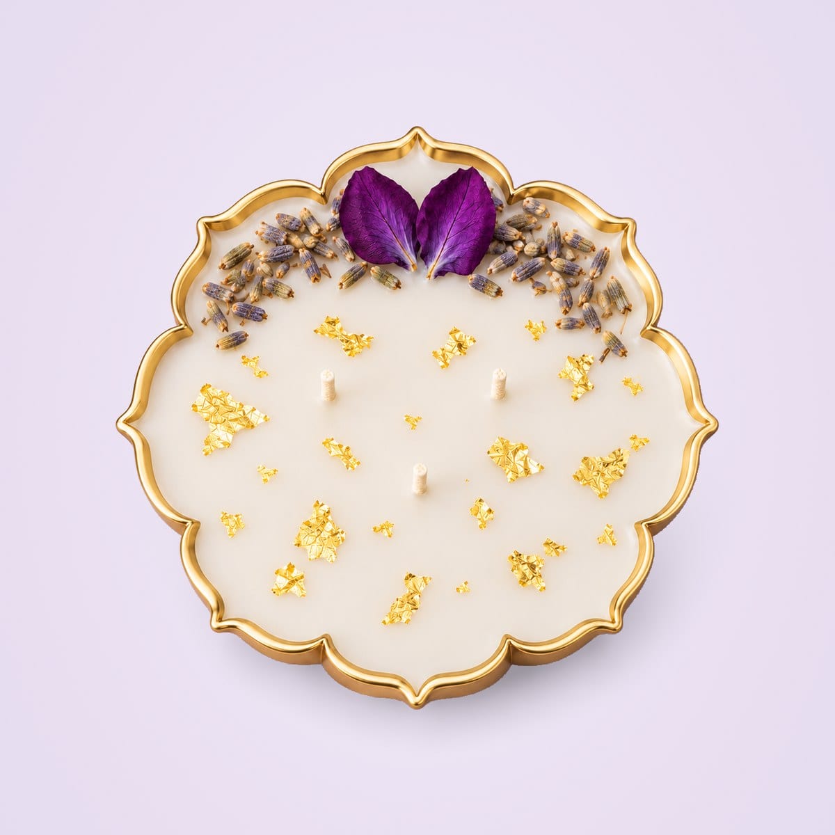 Lavender urli candle from above, showing the eight-lobed gold rim and three wicks