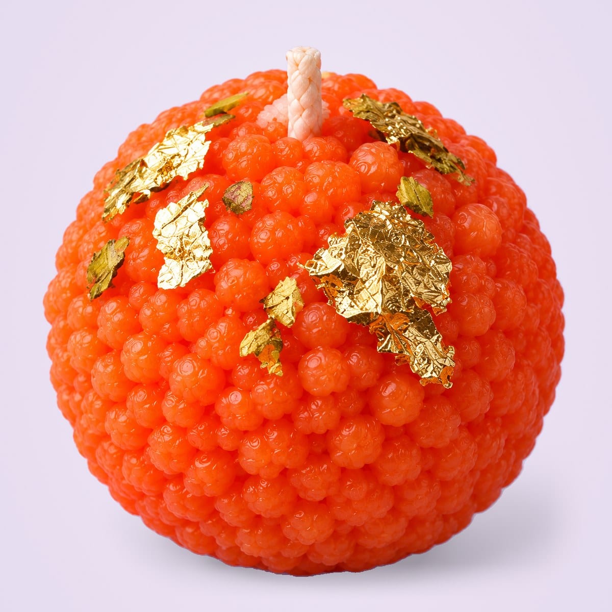 A single motichoor laddu candle, showing its granular wax
