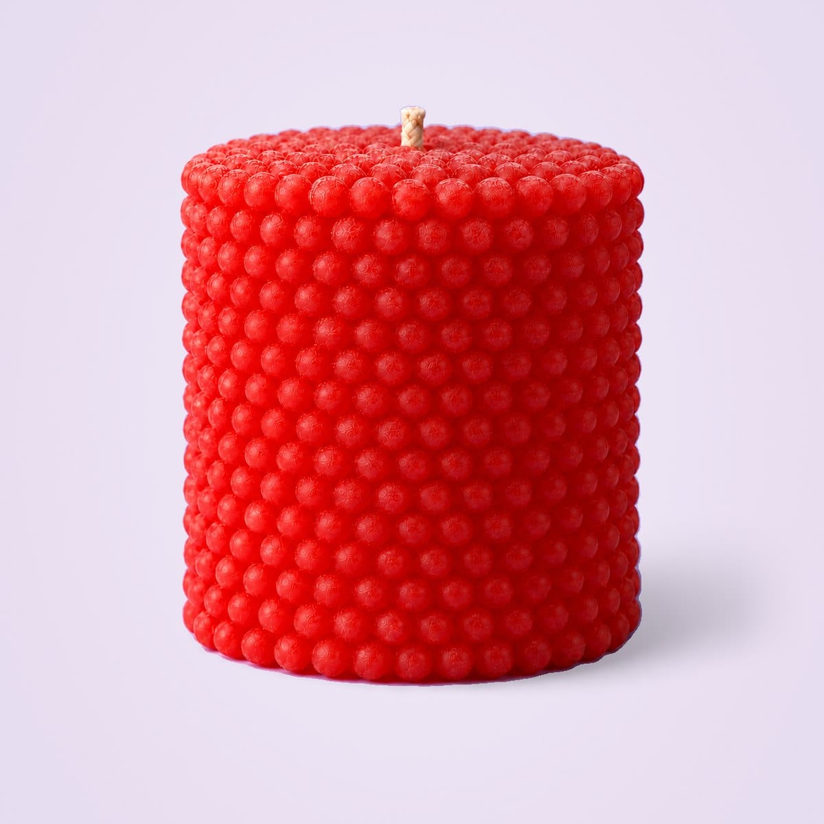 Red pearl pillar candle covered in small wax pearls