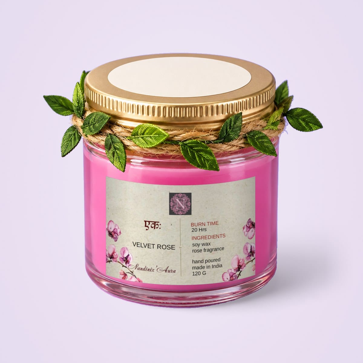 Pink glass jar candle with a gold lid and leaf trim