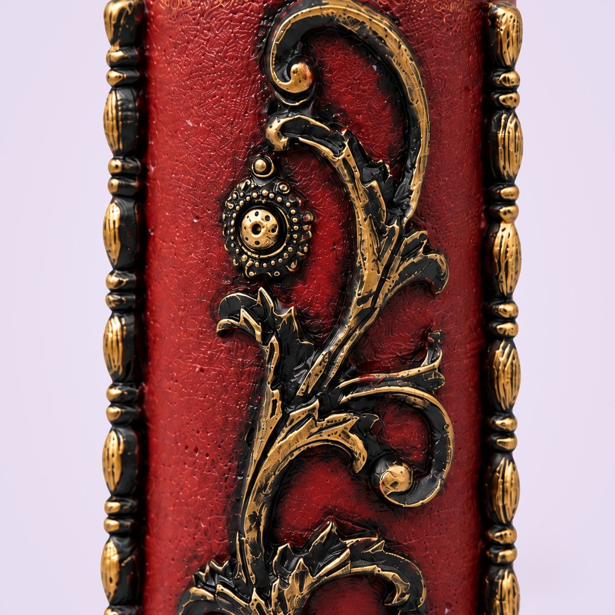 Close-up of the maroon scroll relief