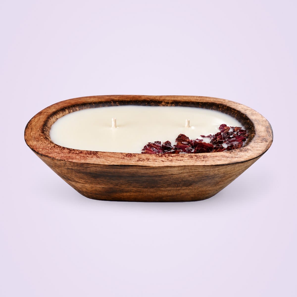 Long wooden dough tub candle with two wicks and dried red rose petals along one side