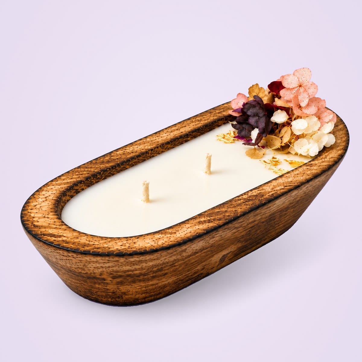 Oval wooden dough tub candle with two wicks and dried flowers